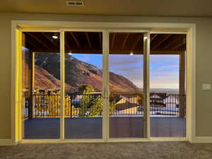 Doorway with carpet flooring and a mountain view