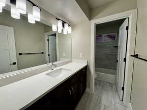 Full bathroom featuring vanity, toilet, and tiled shower / bath