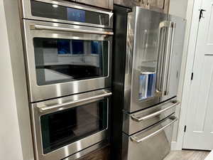 Kitchen featuring light wood-type flooring and stainless steel appliances