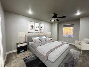 Carpeted bedroom with ceiling fan