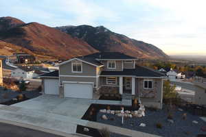 View of front of home with a mountain view and a garage