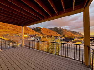 Deck at dusk featuring a mountain view