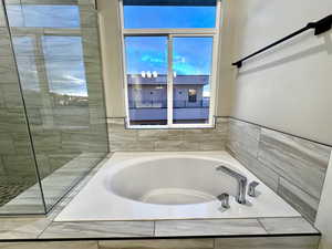 Primary bathroom with tiled bath