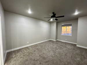 Carpeted primary bedroom featuring ceiling fan