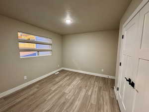 Interior space with a textured ceiling and light wood-type flooring