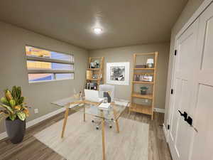 Office featuring hardwood / wood-style floors and a textured ceiling