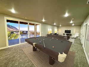 Recreation room featuring a mountain view, carpet floors, a textured ceiling, and billiards