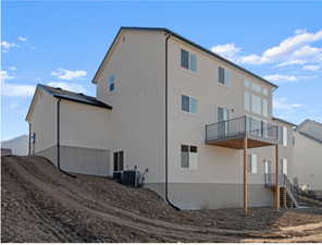 Rear view of house with central AC unit