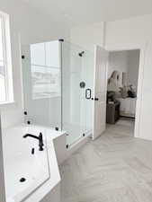 Ensuite bathroom featuring a garden tub, a shower stall, and ensuite bath