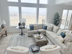 Living room with baseboards, visible vents, and light wood finished floors