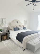 Bedroom featuring vaulted ceiling, light carpet, and ceiling fan