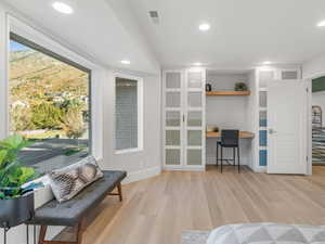 Interior space with light wood-type flooring and built in desk