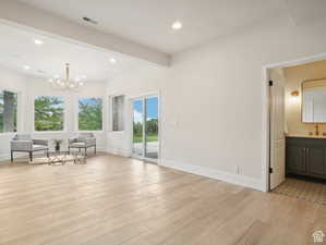 Interior space featuring sink, beamed ceiling, and light hardwood / wood-style floors