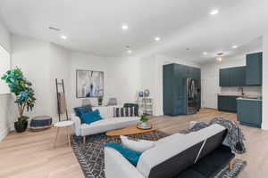 Living room featuring light hardwood / wood-style flooring and sink