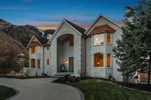 View of front of property featuring a lawn and a mountain view