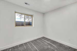 Unfurnished room with carpet flooring