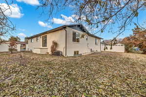 Back of house with central AC unit