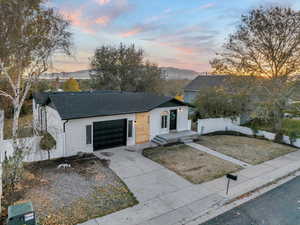 View of front of house with a mountain view and a garage