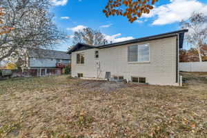 Rear view of house featuring a lawn