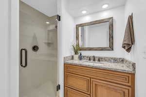 Bathroom with a shower with door and vanity