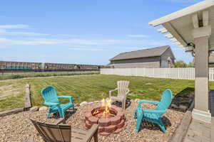 View of patio with an outdoor fire pit