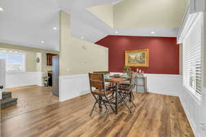 Dining space with wood-type flooring and lofted ceiling