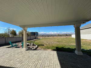 View of patio with an outdoor fire pit