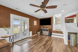 Living room with wood-type flooring and ceiling fan