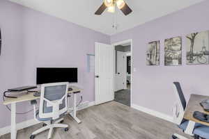 Office area featuring ceiling fan and light wood-type flooring