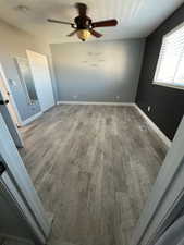 Unfurnished room with hardwood / wood-style floors and ceiling fan