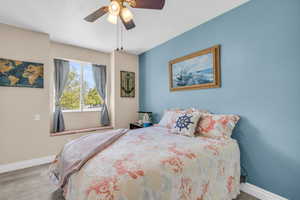 Bedroom with ceiling fan and light hardwood / wood-style flooring