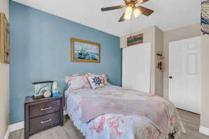 Bedroom featuring a closet, light hardwood / wood-style floors, and ceiling fan