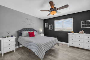 Bedroom featuring ceiling fan and light hardwood / wood-style floors