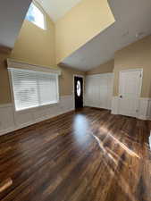 Entryway featuring dark hardwood / wood-style flooring and vaulted ceiling