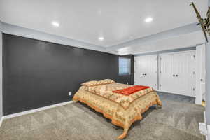 Carpeted bedroom featuring two closets