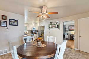 Dining area with ceiling fan and light hardwood / wood-style floors