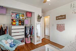 Bedroom featuring a closet, hardwood / wood-style floors, and ceiling fan