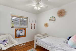 Bedroom featuring wood-type flooring and ceiling fan