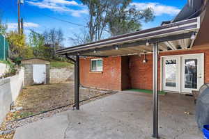 View of patio / terrace featuring a shed