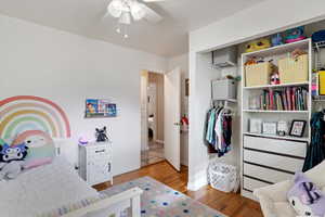 Bedroom with ceiling fan and hardwood / wood-style floors