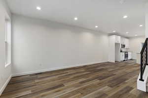 Unfurnished living room with dark hardwood / wood-style flooring