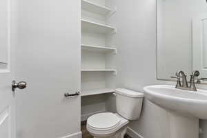 Bathroom featuring wood-type flooring and toilet