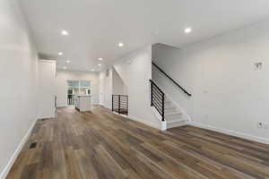 Unfurnished living room with dark hardwood / wood-style flooring