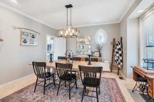 Dining space with a notable chandelier and crown molding