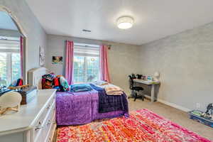 Bedroom featuring light colored carpet