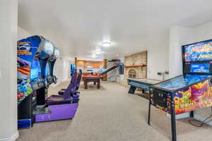 Rec room with a brick fireplace and carpet floors