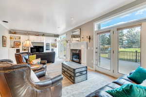 Living room featuring a high end fireplace and ornamental molding