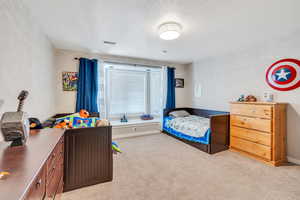 Bedroom with light colored carpet