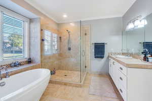 Bathroom with vanity, walk in shower, tile patterned flooring, and crown molding