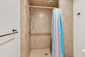 Bathroom with a shower with shower curtain